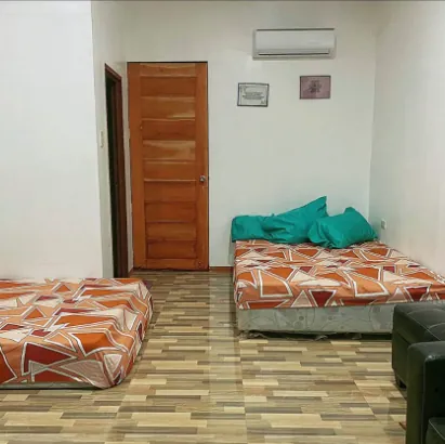 An air-conditioned room with mattresses and patterned sheets