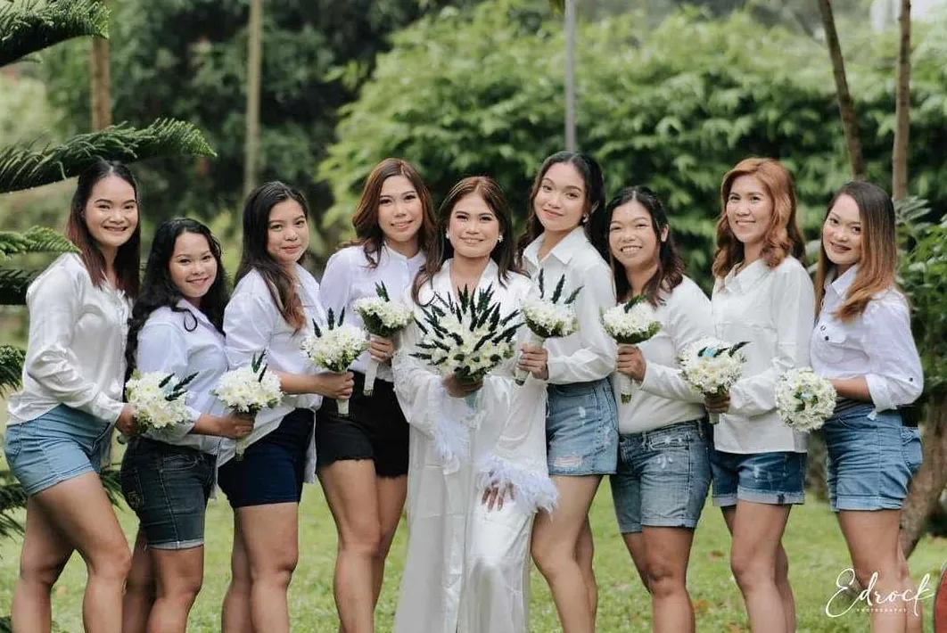Guests in white gathered on the lawn for a celebration