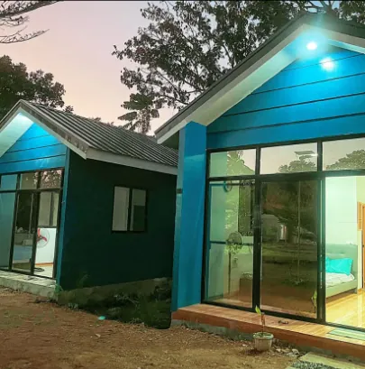 One of the blue tiny houses with large glass doors